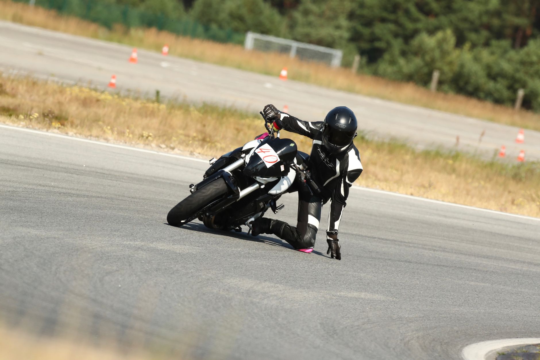 motorcycle leaning through a corner on a race circuit